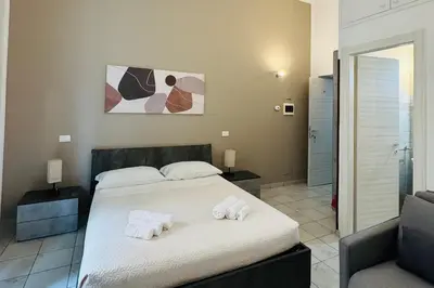 a bedroom with a large bed with towels on it at Bosuites Rome in Rome