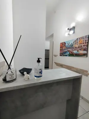 a counter with a bottle of soap and a painting at Bosuites Rome in Rome
