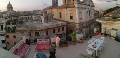 a woman standing on the balcony of a building at Terrace Apartment On The Monuments Of Rome in Rome