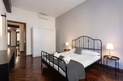 a bedroom with a bed with a black metal frame at Borgo Terrace by Rental in Rome in Rome