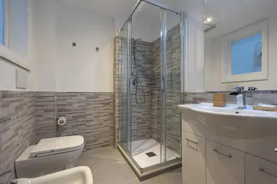a bathroom with a shower and a toilet and a sink at Borgo Terrace by Rental in Rome in Rome
