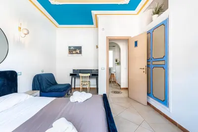 a bedroom with a bed and a table and a chair at Gregorio VII - Deliziosa sistemazione a due passi da San Pietro in Rome