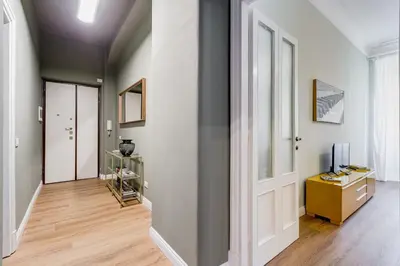 a hallway with a white door and a television at Flaminio Lovely House in Rome
