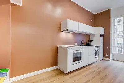a kitchen with a washer and dryer in a room at Flaminio Lovely House in Rome
