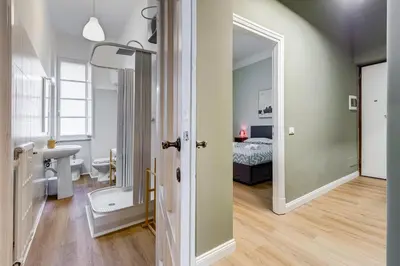 a room with a bathroom and a bedroom with a bed at Flaminio Lovely House in Rome