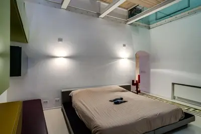 a living room with a couch and a chair at Trevi Loft in Rome