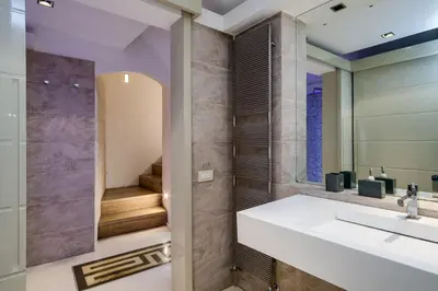 a room with a glass desk with a television at Trevi Loft in Rome