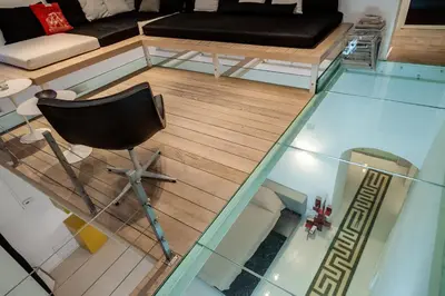 a living room with a black couch and a chair at Trevi Loft in Rome
