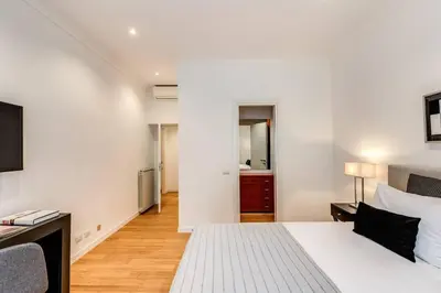 a bedroom with a large white bed and a desk at Charming flat by the Vatican in Rome