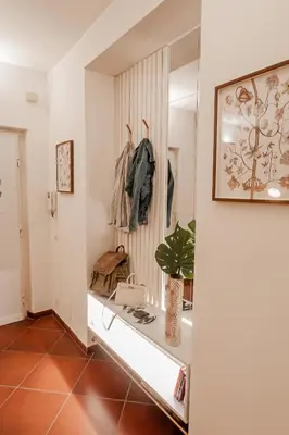 a dressing room with a shelf and a mirror at Alloggio Re di Roma 43 in Rome