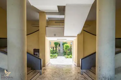 an apartment building with a garden in front of it at Mr Brown - Monteverde House in Rome