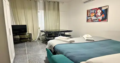 a room with a bed and a table and a tv at Massi Vatican House in Rome