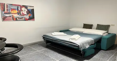 a bedroom with a bed and a painting on the wall at Massi Vatican House in Rome