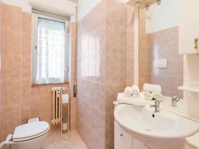 a bathroom with a toilet and a sink at Massi Vatican House in Rome