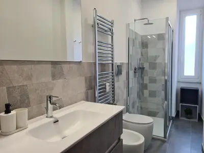 a bathroom with a sink and a toilet and a shower at Nox Romana Apartments - Vatican - Threeroom Apt with 2 Bathroom in Rome
