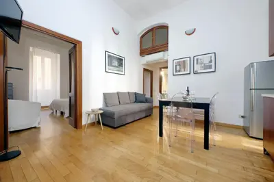 a living room with a couch and a glass table at Vatican Spacious Modì Apartment in Rome