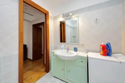 a bathroom with a sink and a mirror at Vatican Spacious Modì Apartment in Rome