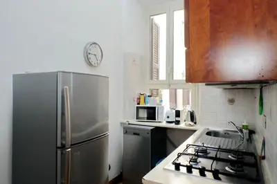 a kitchen with a stainless steel refrigerator and a stove at Vatican Spacious Modì Apartment in Rome