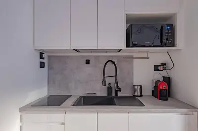 a kitchen with a sink and a microwave at Modern Apartment at San Giovanni in Rome