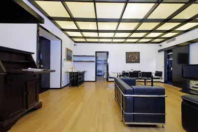a living room with a piano and a table at 4BNB - Spacious Porta Pia Apartment in Rome