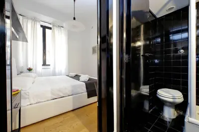 a bedroom with a bed and a bathroom with a toilet at 4BNB - Spacious Porta Pia Apartment in Rome