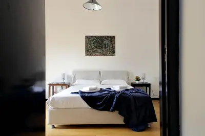 a bedroom with a bed with a blue blanket on it at 4BNB - Spacious Porta Pia Apartment in Rome