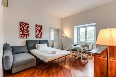 a living room with a couch and a table at Splendid flat on the Tiber river in Rome