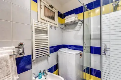 a small bathroom with a toilet and a sink at Splendid flat on the Tiber river in Rome