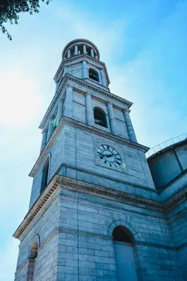 a tall tower with a clock on top of a building at PLANT HOUSE Roma San Paolo in Rome