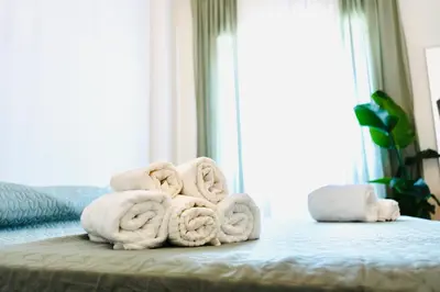 a pile of towels sitting on top of a bed at PLANT HOUSE Roma San Paolo in Rome