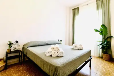 a bedroom with a bed with towels on it at PLANT HOUSE Roma San Paolo in Rome
