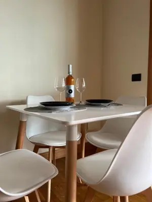 a white table with two glasses and a bottle of wine at Mary's house in Rome