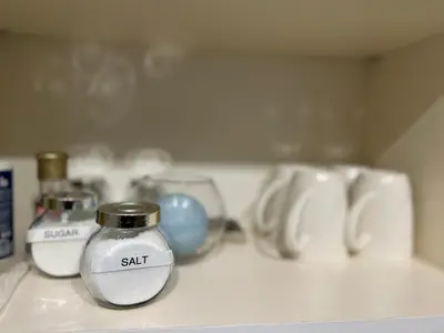 a bottle of salt sitting on top of a counter at Mary's house in Rome