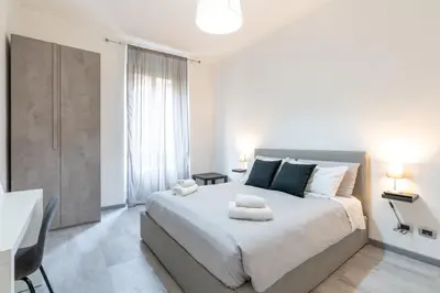 a bedroom with a large bed with two towels on it at Amazing apartment near to Colosseo and subway in Rome