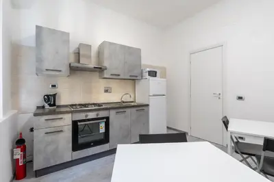 a kitchen with stainless steel appliances and a table at Amazing apartment near to Colosseo and subway in Rome
