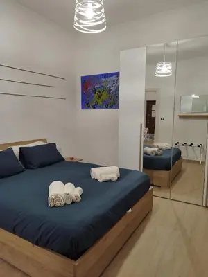 a bedroom with a bed with towels on it at Appartamento Elena & Chiara in Rome