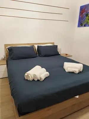 two towels on a bed with two pillows at Appartamento Elena & Chiara in Rome