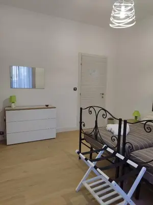 a bedroom with a bed and a dresser in a room at Appartamento Elena & Chiara in Rome