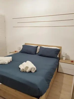 a bedroom with two towels on a bed at Appartamento Elena & Chiara in Rome