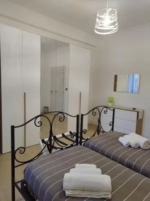 a bedroom with a bed with towels on it at Appartamento Elena & Chiara in Rome