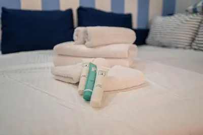 a pile of towels and towels on a bed at Anna’s Crazy Place in Rome