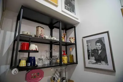 a shelf on a wall with a picture of a man at Anna’s Crazy Place in Rome