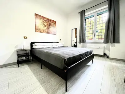 a bedroom with a large bed and a window at Vatican Home Holidays in Rome