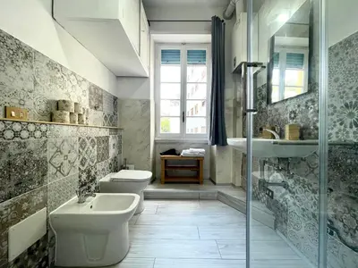 a bathroom with two toilets and a sink and a shower at Vatican Home Holidays in Rome