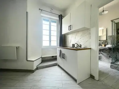 a white kitchen with a sink and a window at Vatican Home Holidays in Rome