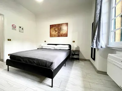 a bedroom with a bed and a painting on the wall at Vatican Home Holidays in Rome