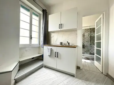 a kitchen with white cabinets and a window at Vatican Home Holidays in Rome