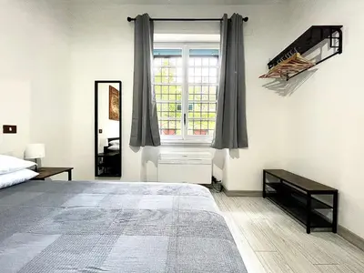 a bedroom with a large bed and a window at Vatican Home Holidays in Rome