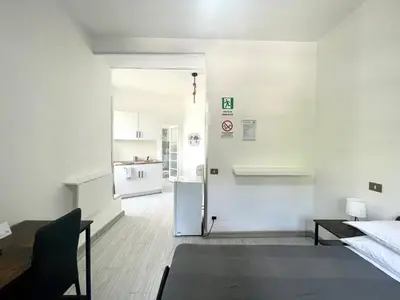 a white room with a refrigerator and a kitchen at Vatican Home Holidays in Rome