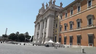 a large building next to a street next to a building at Giovanni Guest House in Rome